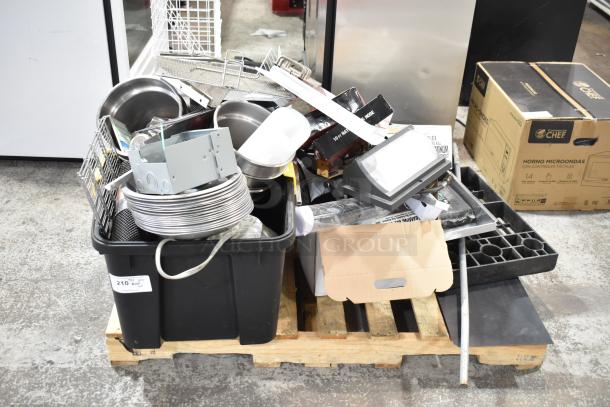 Pallet with mixed items including metal pans, drop-in bins, white baskets, on black and wooden containers, fair condition.