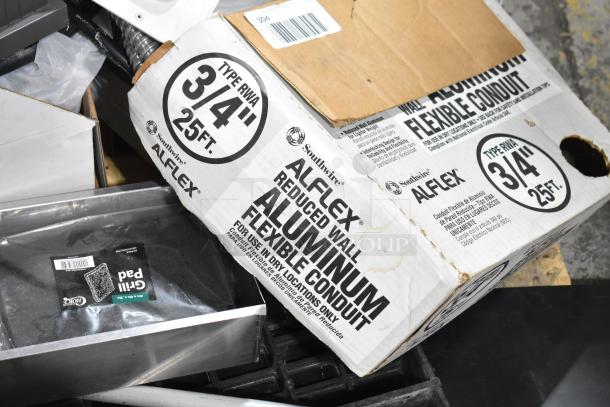 Pallet with metal round pans, cylindrical drop-in bins, white baskets, and Southwire Alfex aluminum flexible conduit box.