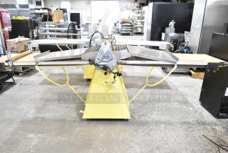 Rondo Seewer commercial reversible dough sheeter, floor model, good condition, stainless steel surfaces, industrial setting.