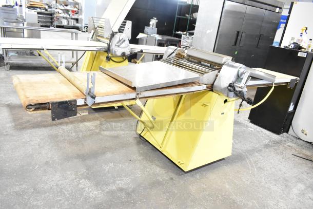 Rondo Seewer commercial floor-style reversible dough sheeter, yellow base, metal rollers, sturdy construction, good condition.