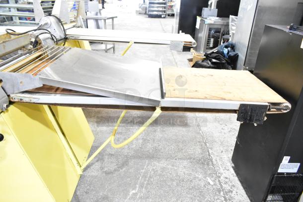 Rondo Seewer commercial reversible dough sheeter in used condition, with adjustable rollers, and metal and wood surfaces.