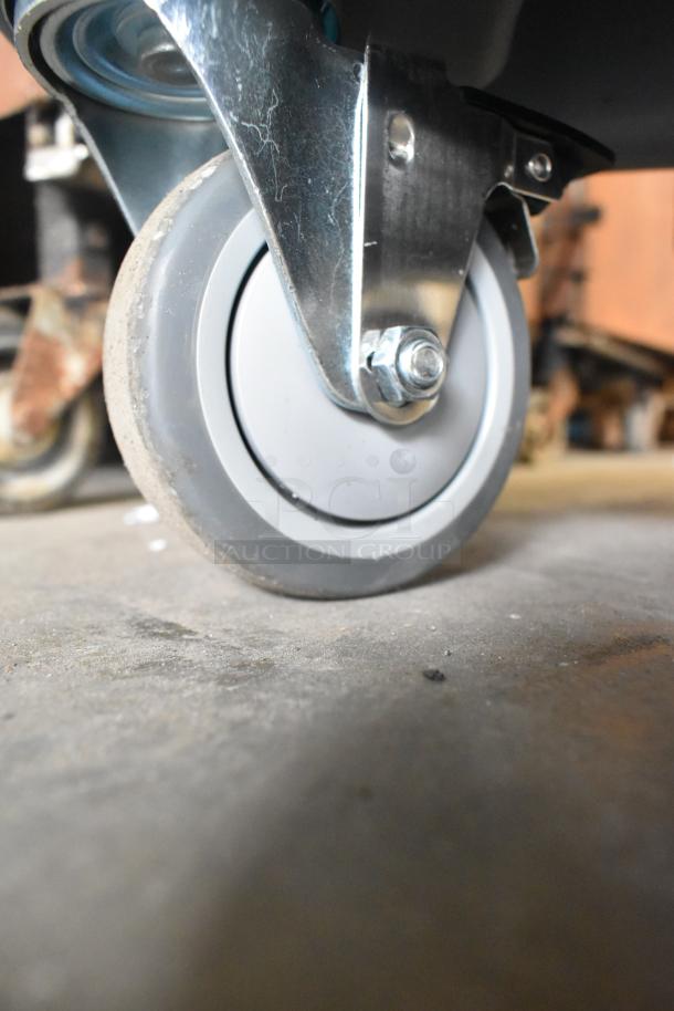 Close-up of a caster wheel on the 2024 Hobart SDPE-11 20 Gallon Salad Dryer, highlighting its mobility feature.