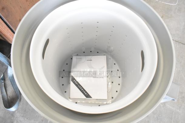 Brand new Hobart SDPE-11 20-gallon electric polyethylene salad dryer, visible manual inside, on commercial casters.