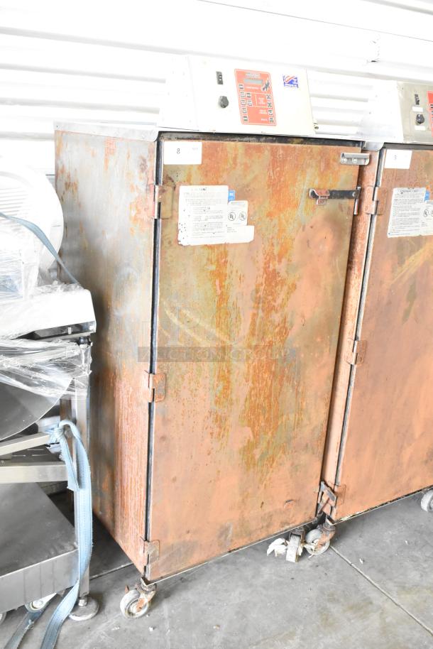 Cookshack 250 Commercial Electric Smoker Cabinet, showing rust, on commercial casters. 208 Volts. Labels with operating info.