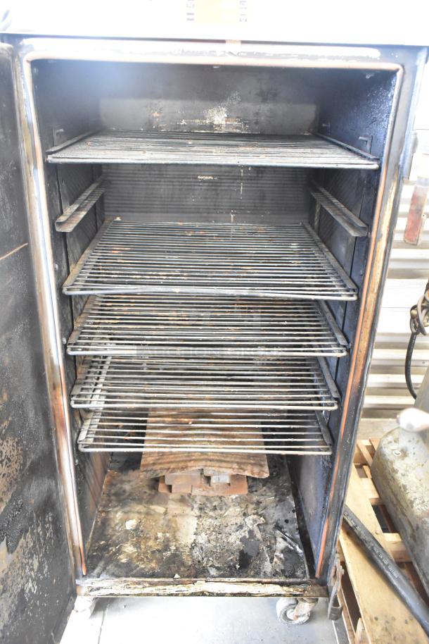 Cookshack 250 commercial electric smoker cabinet with racks, on commercial casters. Used condition, 208 volts.