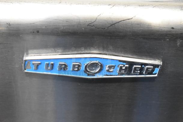 Turbochef oven logo on stainless steel surface, showing wear. Model: HhC2020, 208/240V, 3-phase electric.
