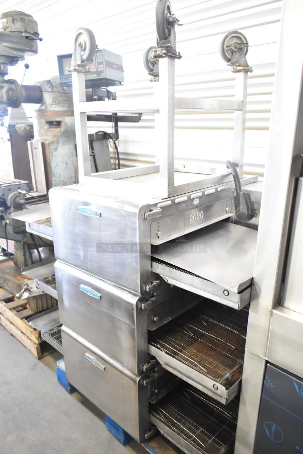 Three 2017 Turbochef HhC2020 electric conveyor ovens on a stand, 208/240V, 3-phase, stainless steel, shows minor wear.