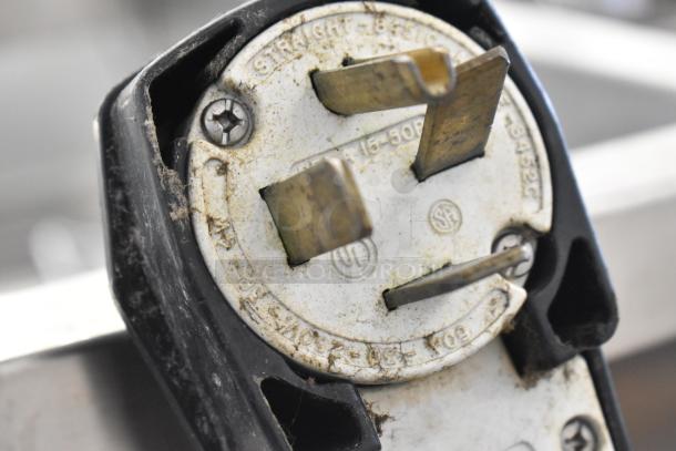 Close-up of plug on Turbochef HhC2020 oven. UL and SF logos visible. Prongs and casing show minor wear.