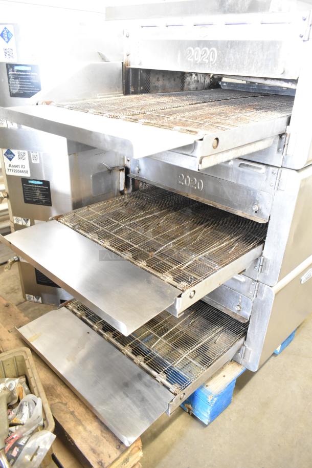 Three 2017 Turbochef HhC2020 conveyor ovens on stand. Electric, 208/240V, 3-phase. Good condition, rapid cook feature. Asset ID visible.