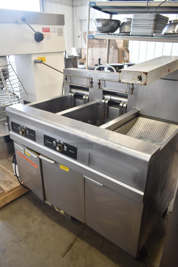 Frymaster FMRE217SC 2-bay electric fryer with dumping station, filtration system, and commercial casters. Good condition.