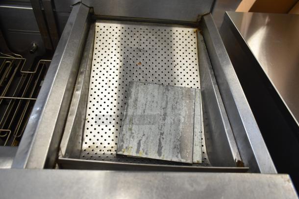 Frymaster FMRE217SC 2 bay deep fat fryer with dumping station, commercial casters, visible signs of use.