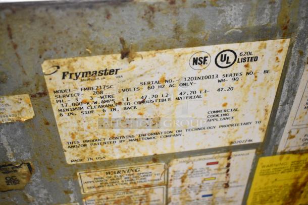 Frymaster FMRE217SC fryer label showing model, voltage, and safety details. Rust present; NSF and UL listed.