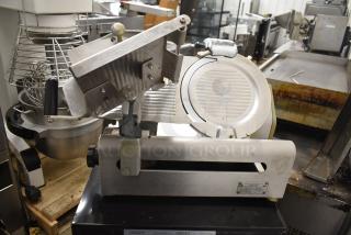 Globe 3600 Commercial Countertop Meat Slicer, 120V, 1 Phase. Stainless steel body with adjustable slicing blade, visible wear.