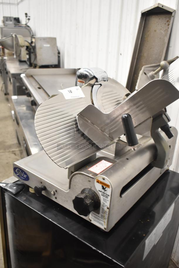 Globe 3600 Commercial Countertop Meat Slicer, 120 Volts, 1 Phase. Stainless steel body, adjustable blade, and safety labels visible.