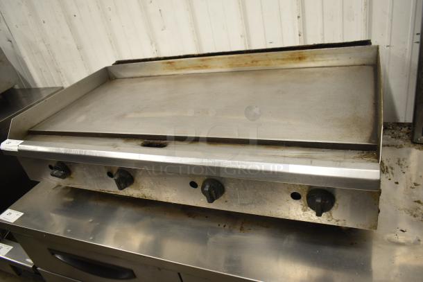 Commercial countertop gas-powered flat top griddle, used condition, featuring three control knobs and stainless steel surface.