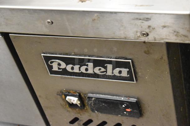 Padela commercial chef base, 4-drawer, on casters. Features visible branding, 115 volts, 1 phase. Exhibits wear.