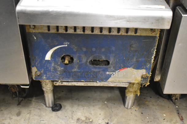 RocketCooking commercial countertop gas charbroiler griddle with a blue control panel, showing signs of heavy use.