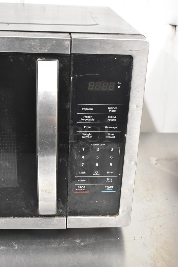 Magic Chef HMM1611ST2 1.6 cu. ft. countertop microwave, 120V, with control panel and various cooking presets.