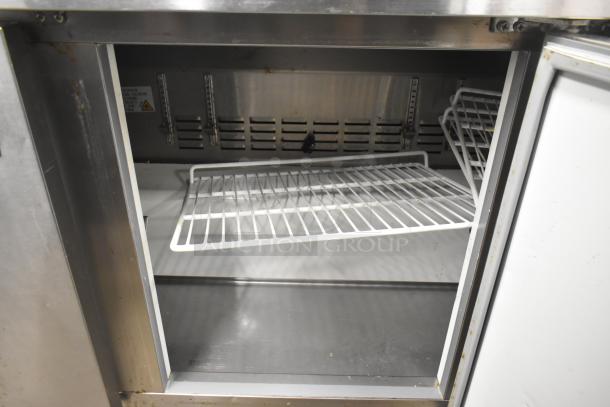 Cooler Depot UUC-72R-E-HC undercounter cooler, three doors, shown open with wire shelves, on commercial casters.