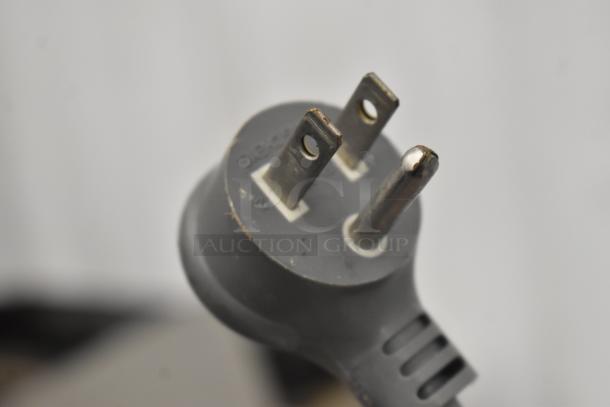 Close-up of Bag Zapper plug, 115 volts, 1 phase, intact condition, suitable for auction buyers.