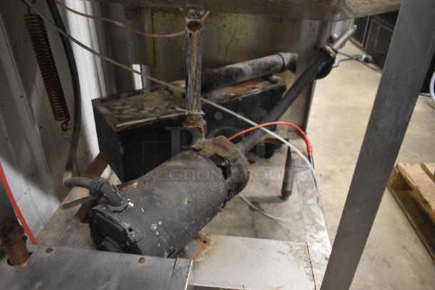 CMA EAH-2 dishwasher base, showing motor and pipes, with signs of wear. 120V, 1 phase. Ideal for commercial use.