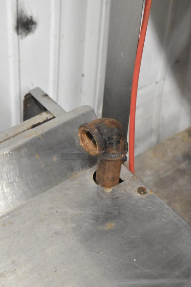 Imperial commercial gas-powered cheese melter with visible rust on metal pipe, showing signs of use and wear.