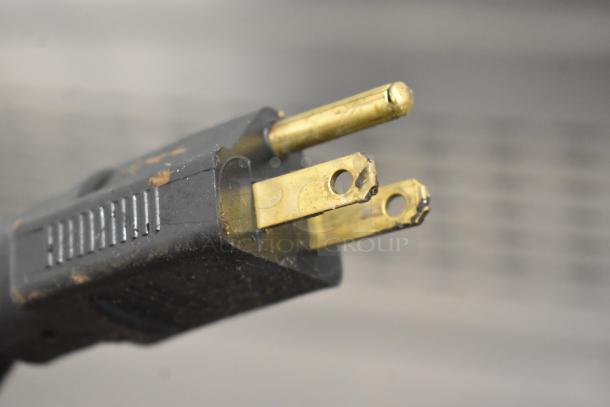 Close-up of a power plug for the RT-P Commercial Countertop Waffle Maker, showing wear and some discoloration.
