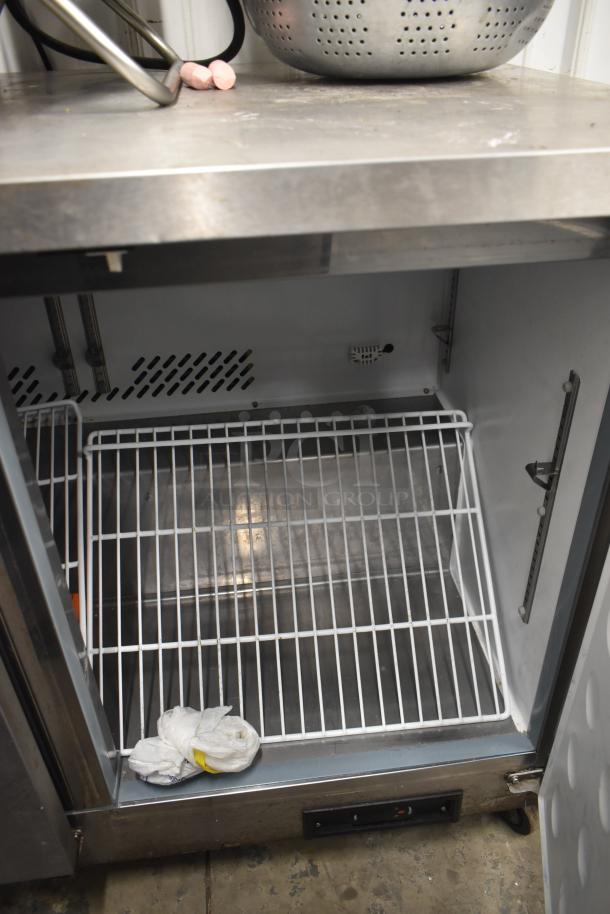 Yukon YUC-72F commercial 3-door undercounter freezer on casters, 115 volts, 1 phase, visible metal shelving, used condition.