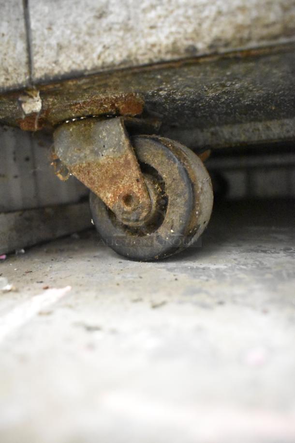 Yukon YUC-72F commercial freezer caster, showing rust and wear. Model supports 115V, 1 phase power, with 3 doors.