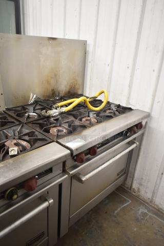 Therma-tek TMD36-6-1N commercial 6 burner gas range with oven, visible wear, yellow gas hose, and backsplash.