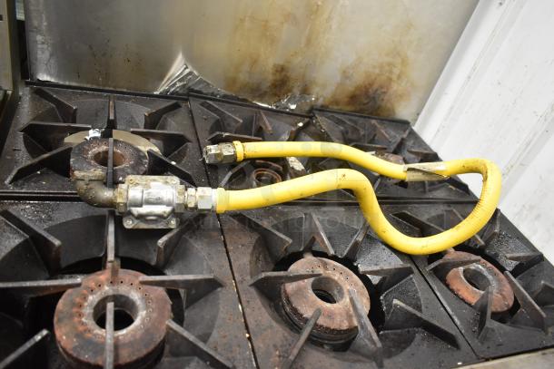 Therma-tek TMD36-6-1N commercial 6 burner gas range with oven, visible wear, includes yellow gas hose.