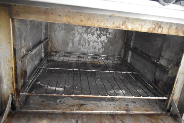 Therma-tek TMD36-6-1N natural gas 6 burner range with oven, showing interior condition. Visible wear from use.