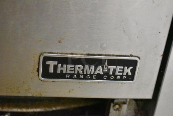 Therma-tek logo on TMD36-6-1N Natural Gas Commercial 6 Burner Range with Oven. Slight wear visible.