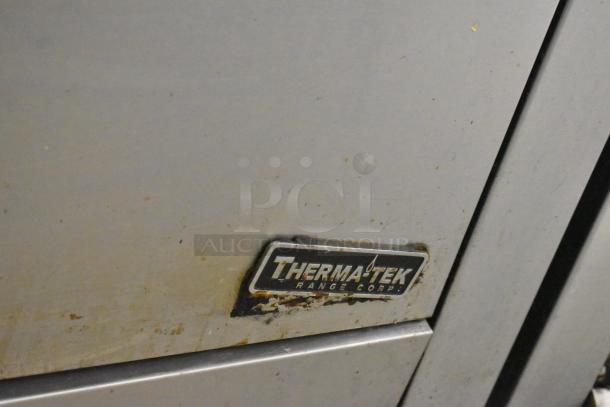 Therma-tek TMD36-6-1N range close-up of brand logo and surface wear; commercial 6-burner, natural gas powered.