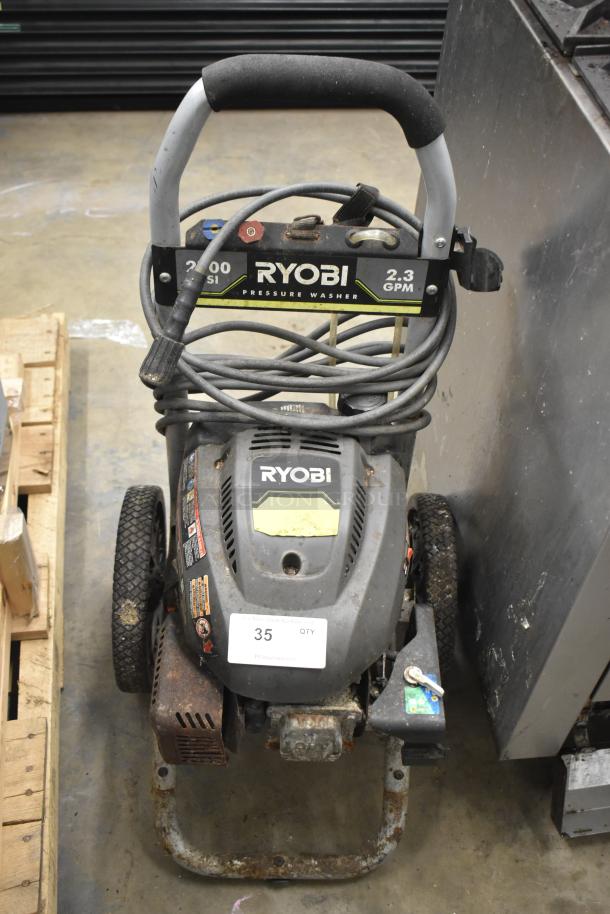 Ryobi 2.3 GPM Pressure Washer with visible hose, handle, and wheels; appears in used condition with some rust.