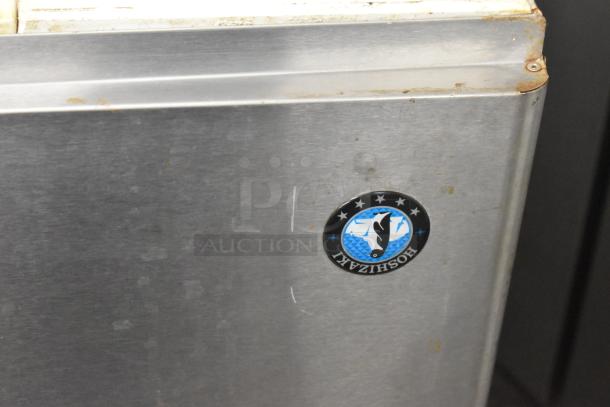 Hoshizaki KM-650MAH ice machine head, steel finish, Hoshizaki logo visible, signs of wear and rust at edges.