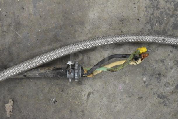 A close-up of electrical and hose connections related to a Hoshizaki KM-650MAH ice machine. Connections appear used.