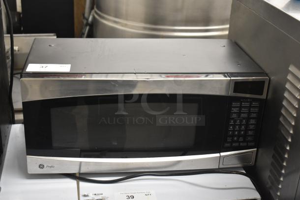 General Electric GE Profile model PEM31SM4SS microwave oven, stainless steel finish, with plate, 120 volts, gently used.