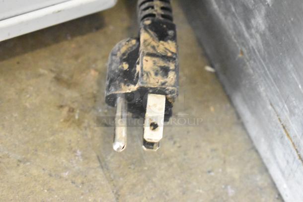 Alt text: Worn electrical plug for ABS ABT-UCFS-0204 undercounter cooler. Plug appears used, with visible dirt marks.