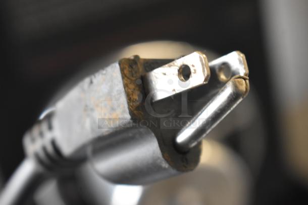 Close-up of a power plug, possibly for the ABS ABT-UCFS-0204 Undercounter Cooler. Plug shows signs of wear.
