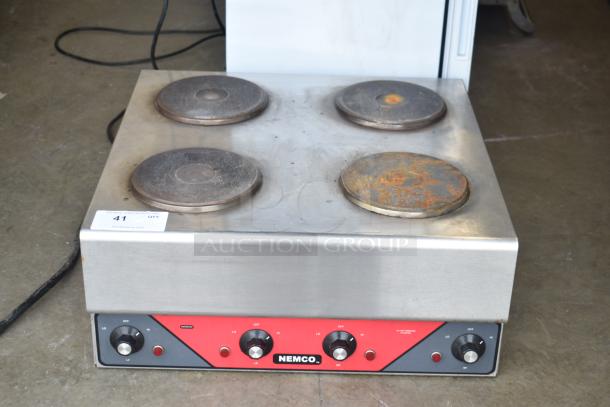 Nemco 6311-2-240 commercial electric 4-burner hot plate range, 240V, 1 phase, showing wear on burners, model label visible.