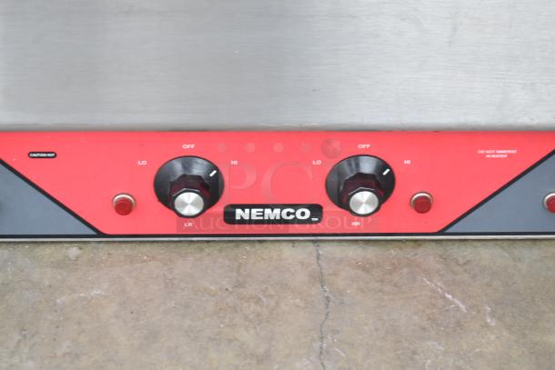 Nemco 6311-2-240 electric 4-burner hot plate, 240V, 1 phase. Features control dials, "Caution Hot" label, and brand logo.