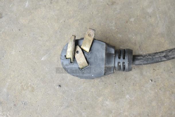 Close-up of a power plug for Nemco 6311-2-240, a 240V commercial electric hot plate. Plug shows wear.