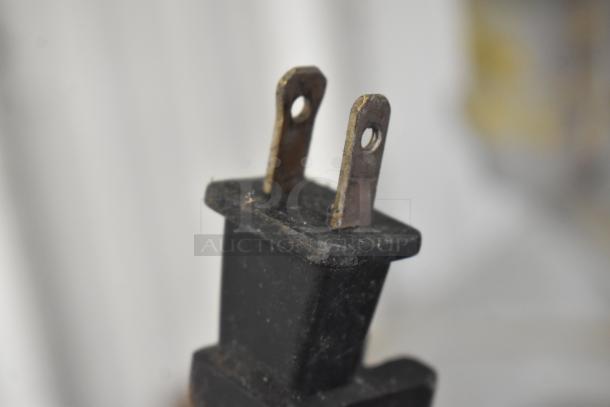 Close-up of power plug for Rigid HD16000 wet dry shop vac. Two-prong, 120 volts, showing some wear.