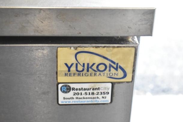 Yukon YUC-60F commercial undercounter freezer, 2 door, on casters. Visible label: "Yukon Refrigeration" with contact info.