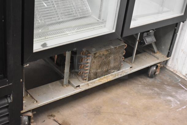 Beverage Air MMR49HC-1-B commercial cooler, two glass doors, visible lower coils, 115V, on casters, moderate wear.