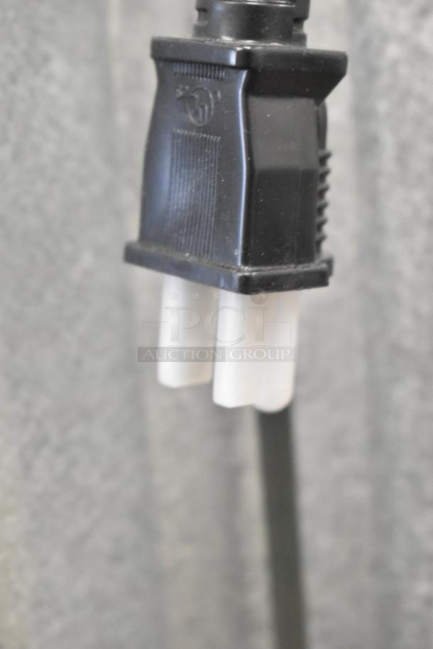 Close-up of the plug for a ServIt 423SW60TLCPA 60" lighted strip warmer, single toggle control, 120V, new condition.