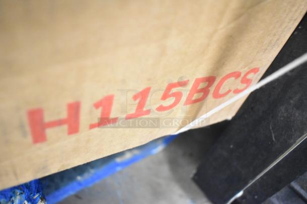 Cardboard box marked "H115BCS" indicating a Honeywell 115 Can Cooler and Beverage Refrigerator, new with scratches and dents.