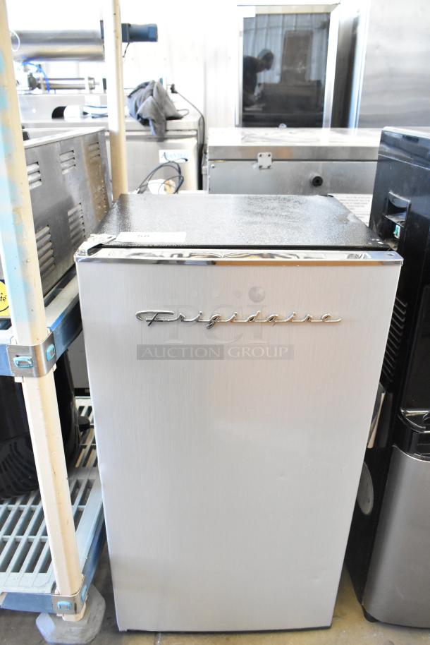 Frigidaire EFR323-6COM Mini Cooler, 115V, 1 Phase, stainless steel finish, shows minimal wear, logo on door.