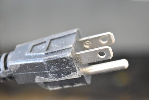 Close-up of a Frigidaire EFR323-6COM mini cooler's power plug, showing a standard 115-volt, 1-phase connection.